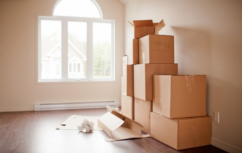 Removal van and moving boxes in a Homerton residential street