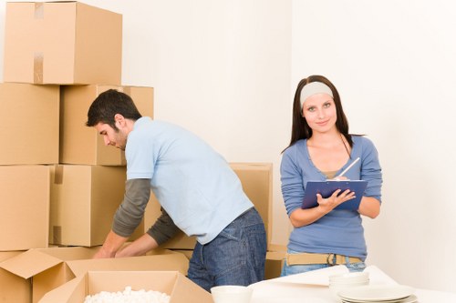 Moving team handling furniture in a Homerton flat