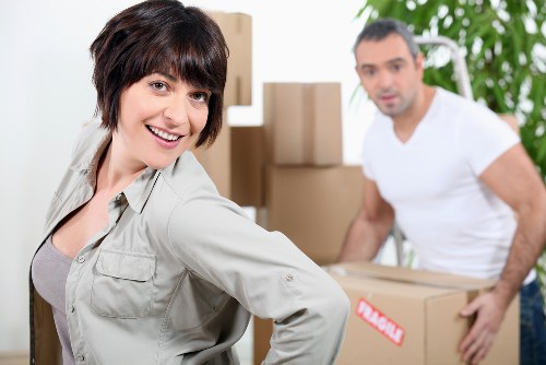 Local moving team loading furniture into a truck